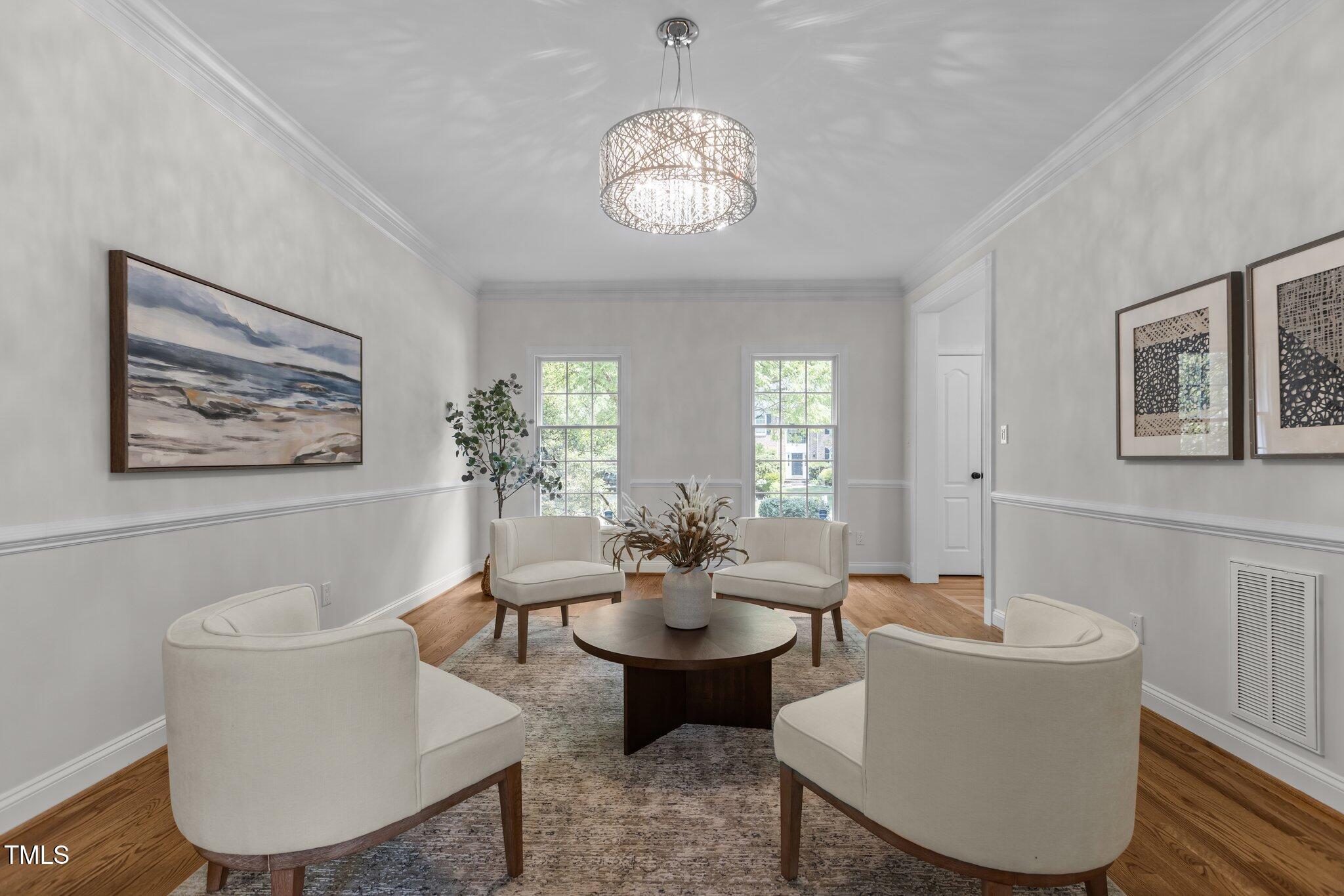 103 Ticonderoga Road Cary, NC 27519 - Photo 5 of 65 a living room with couches a mirror and a table with wooden floor