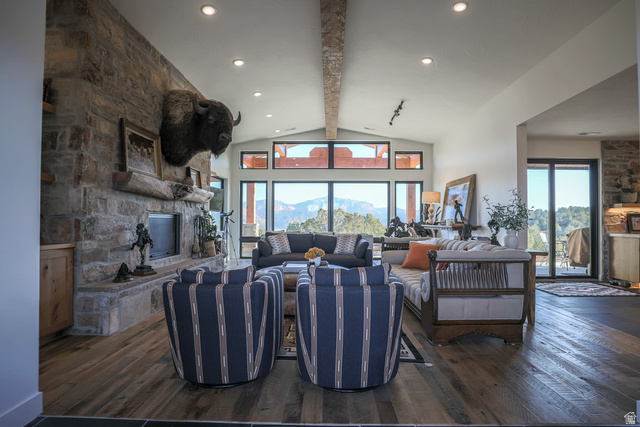 6688 Bareback Road Cedar City, UT 84720 - Photo 12 of 58 stone fireplace, dark wood-style flooring, lofted ceiling, a mountain view, and recessed lighting