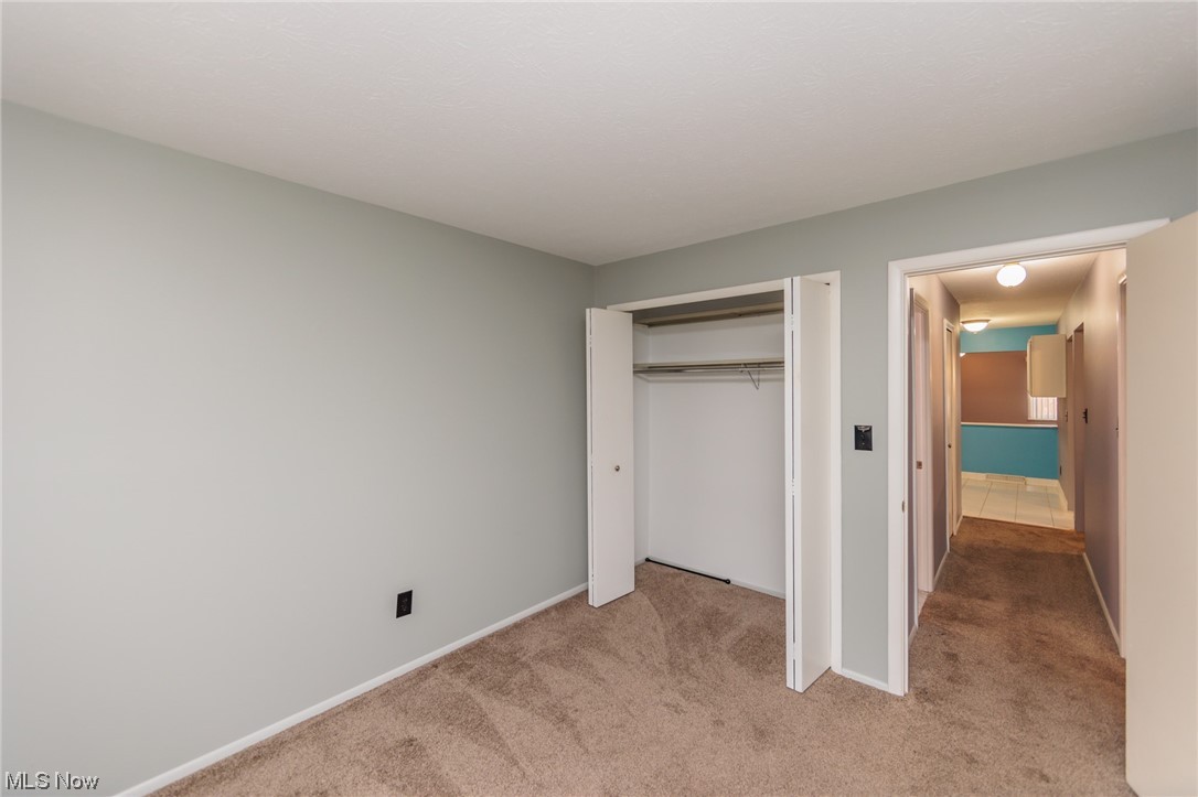 6472 State Road, Unit J19 Parma, OH 44134 - Photo 28 of 33 Unfurnished bedroom with light carpet and a closet