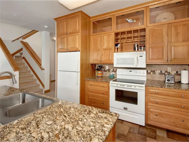 a living room with furniture a rug and a fireplace