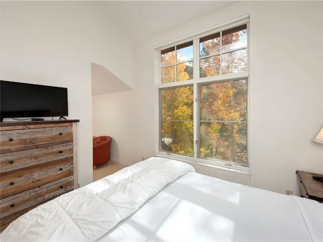 a bedroom with a bed and a night stand