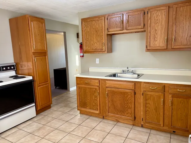 a kitchen with stainless steel appliances granite countertop a refrigerator and cabinets