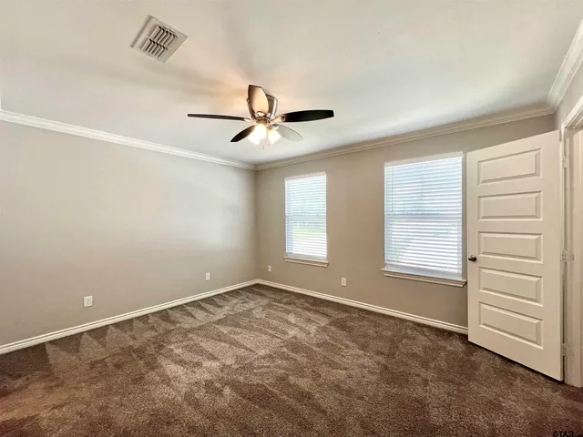 a view of a livingroom with a ceiling fan and window
