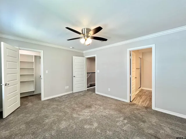 a view of an empty room with a ceiling fan