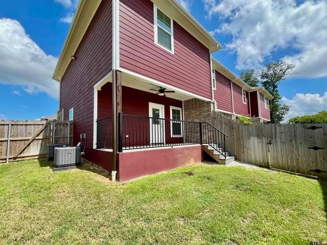 a view of a house with backyard porch and sitting area