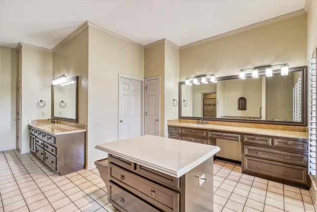 a spacious bathroom with a granite countertop sink a mirror and a bathtub