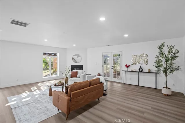 a living room with furniture and wooden floor