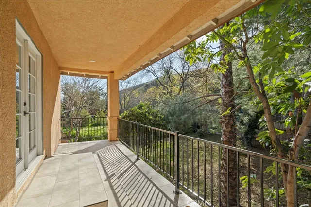 a balcony with trees in front of it