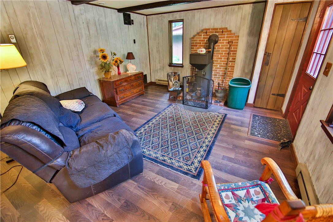 8 Cross Rds Drive Jim Thorpe, PA 18229 - Photo 10 of 32 A charming living space features a cozy wood-burning stove and rustic wood accents.