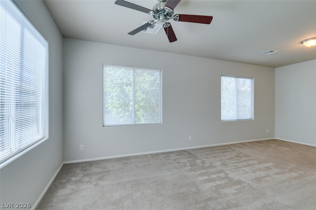 8937 Caledon Ridge Court Las Vegas, NV 89149 - Photo 34 of 43 Plenty of natural light fills this generously sized room, complete with soft carpeting and a cooling ceiling fan.