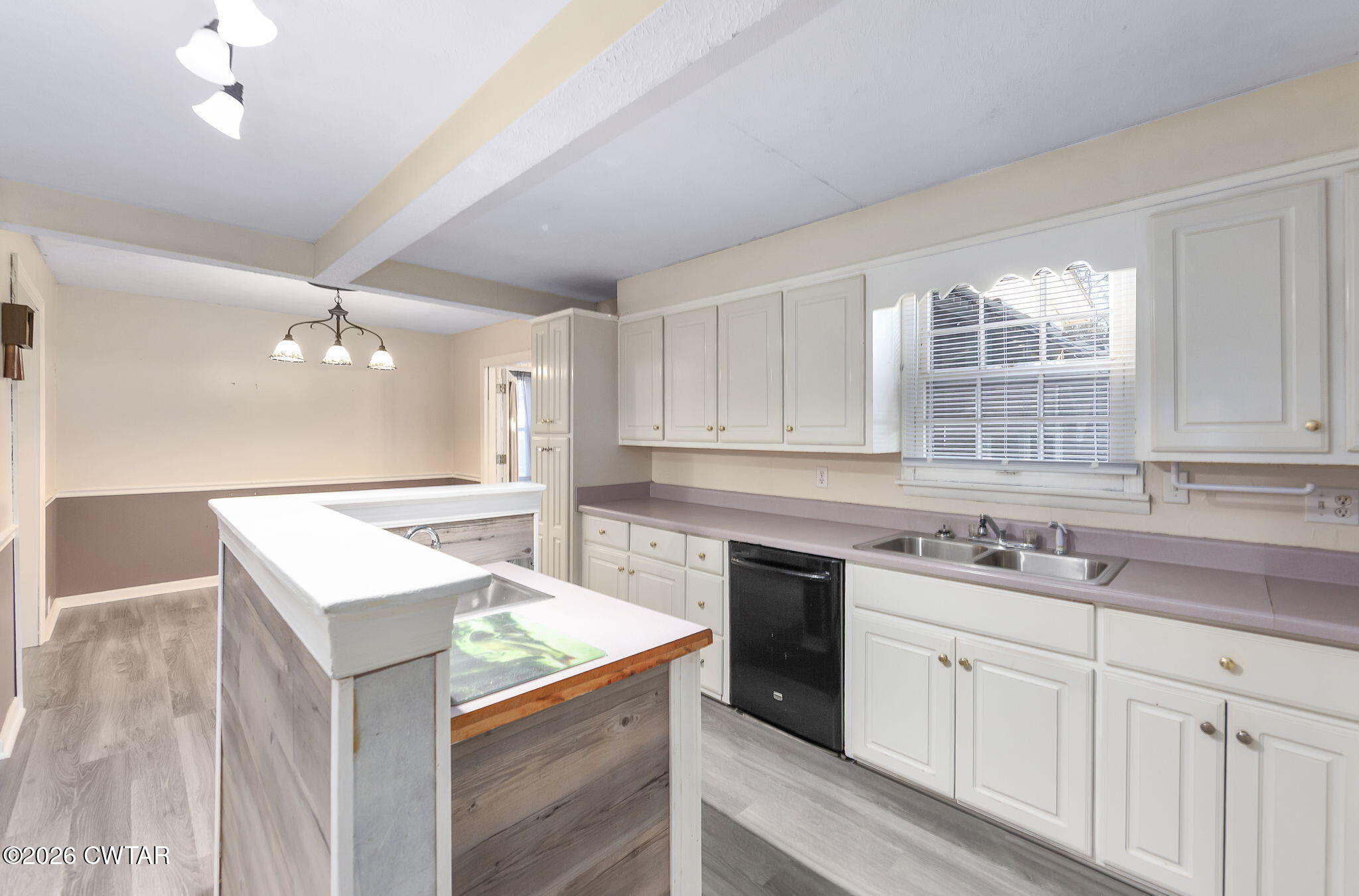 4 Farwell Street Jackson, TN 38301 - Photo 2 of 25 a kitchen that has a sink a stove and dishwasher with wooden floor