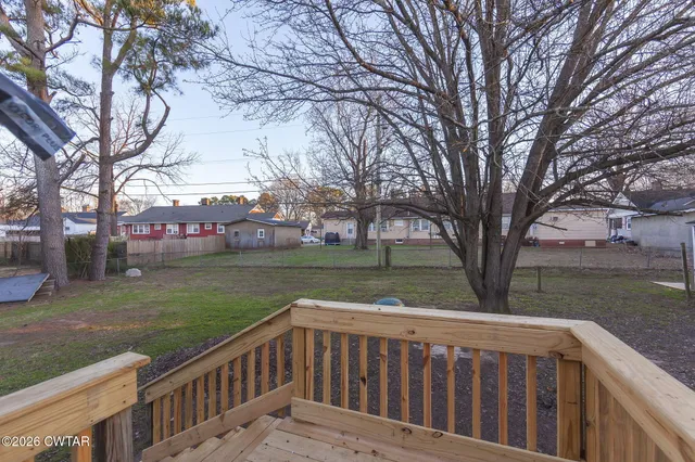 a view of wooden deck and a garden