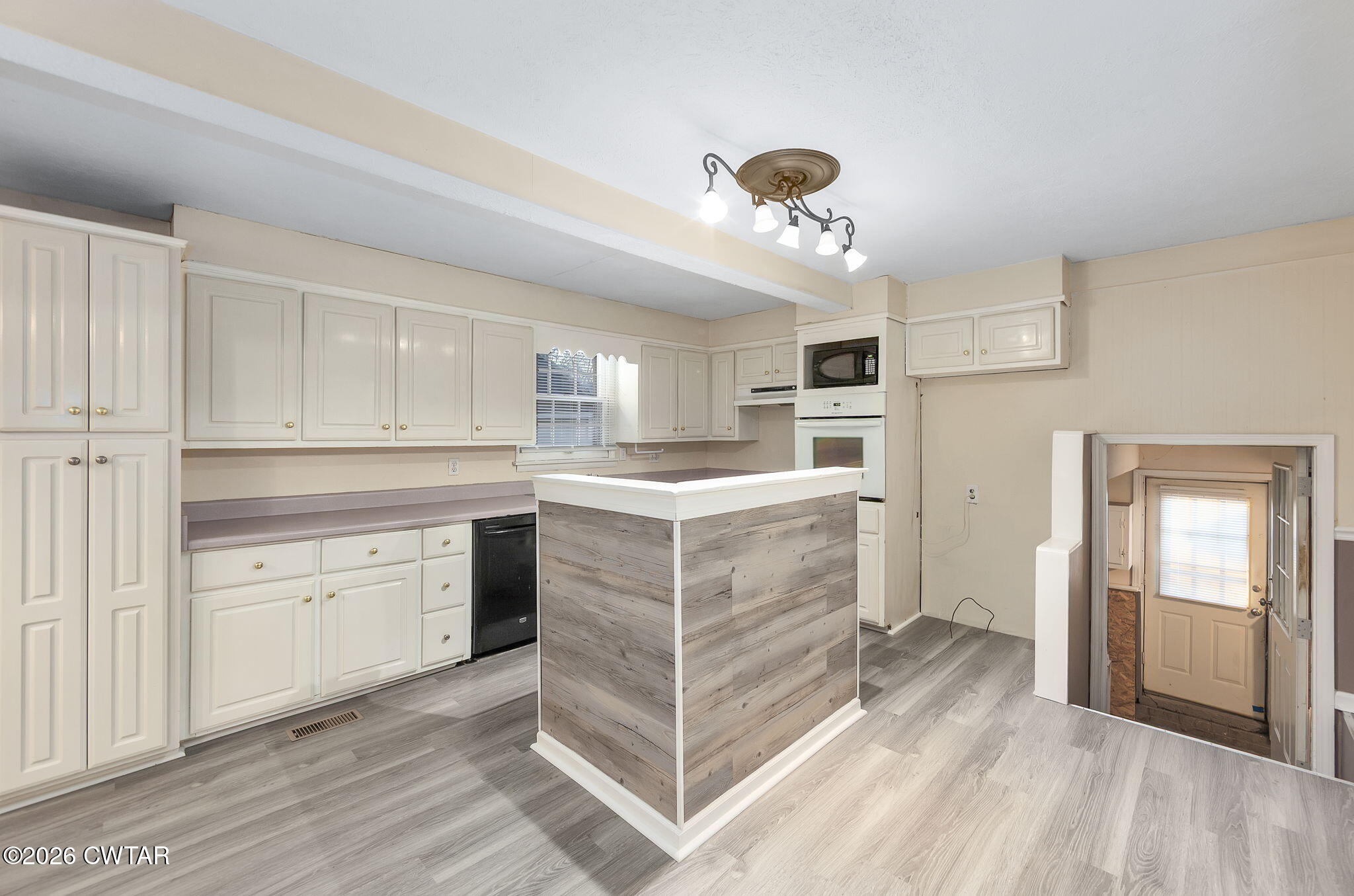 4 Farwell Street Jackson, TN 38301 - Photo 5 of 25 a kitchen with a white cabinets and chandelier