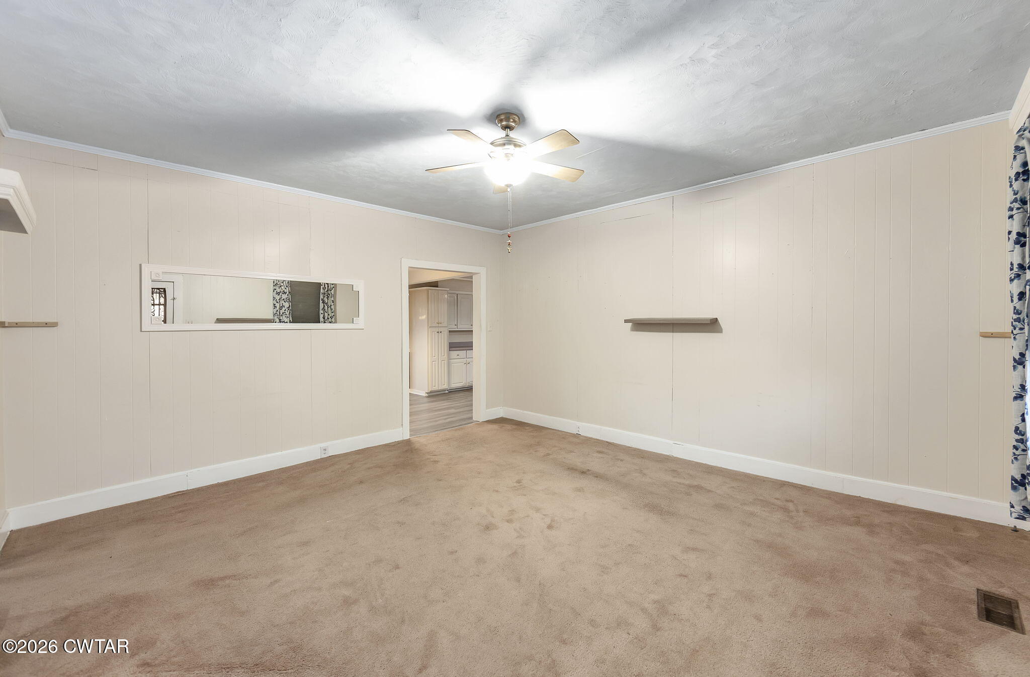 4 Farwell Street Jackson, TN 38301 - Photo 10 of 25 an empty room with a chandelier fan and windows