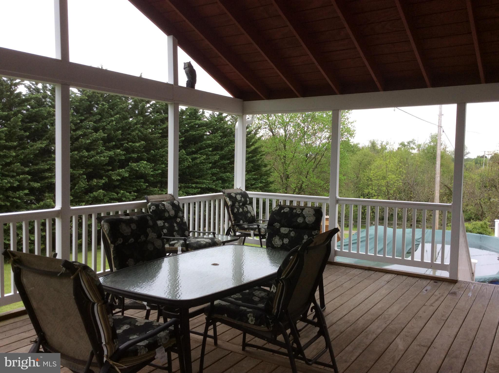 2601 Old Washington Road Westminster, MD 21157 - Photo 16 of 27 a view of a deck with a table and chairs with wooden floor