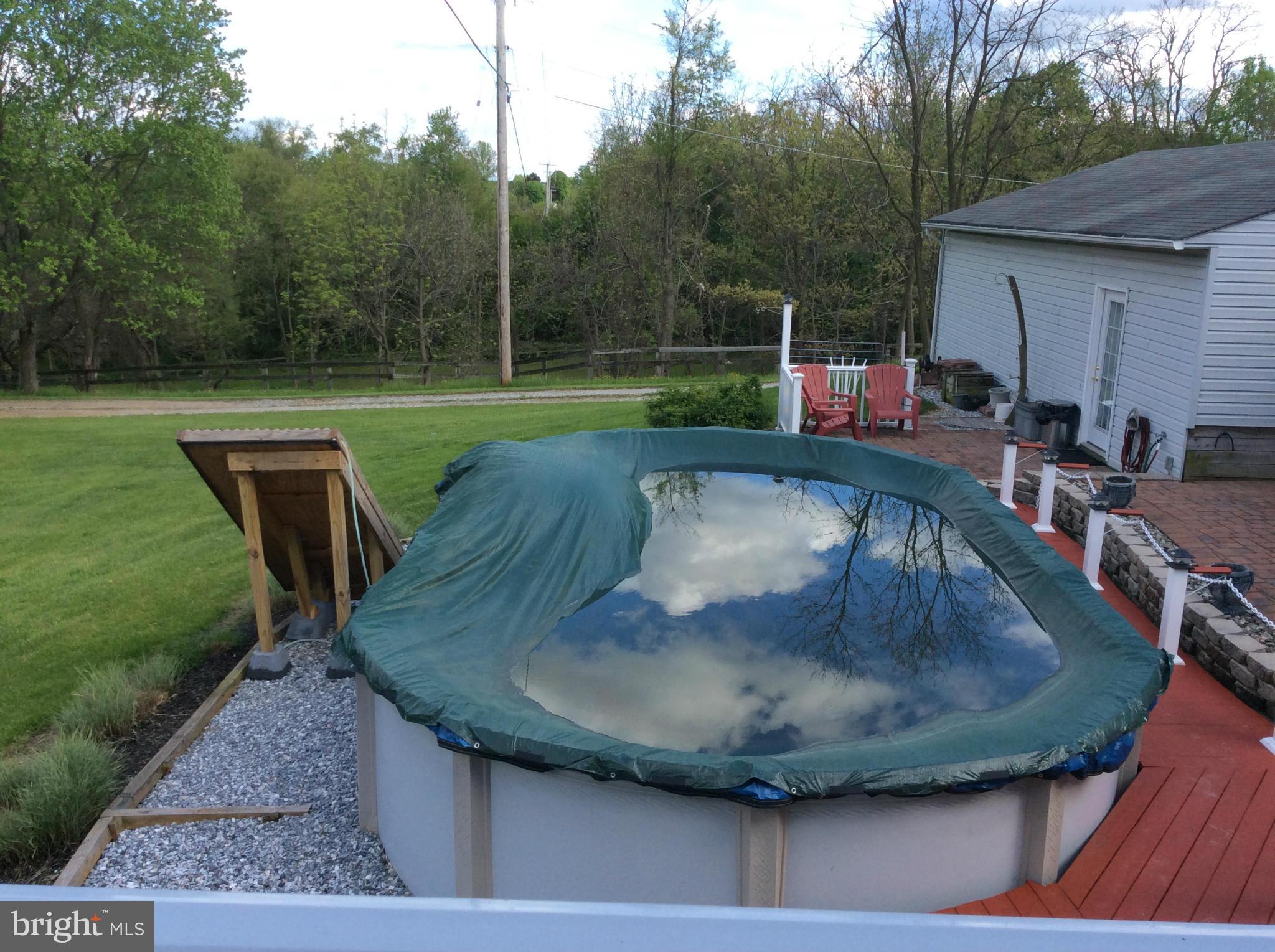 2601 Old Washington Road Westminster, MD 21157 - Photo 23 of 27 a view of a swimming pool with a patio and a garden