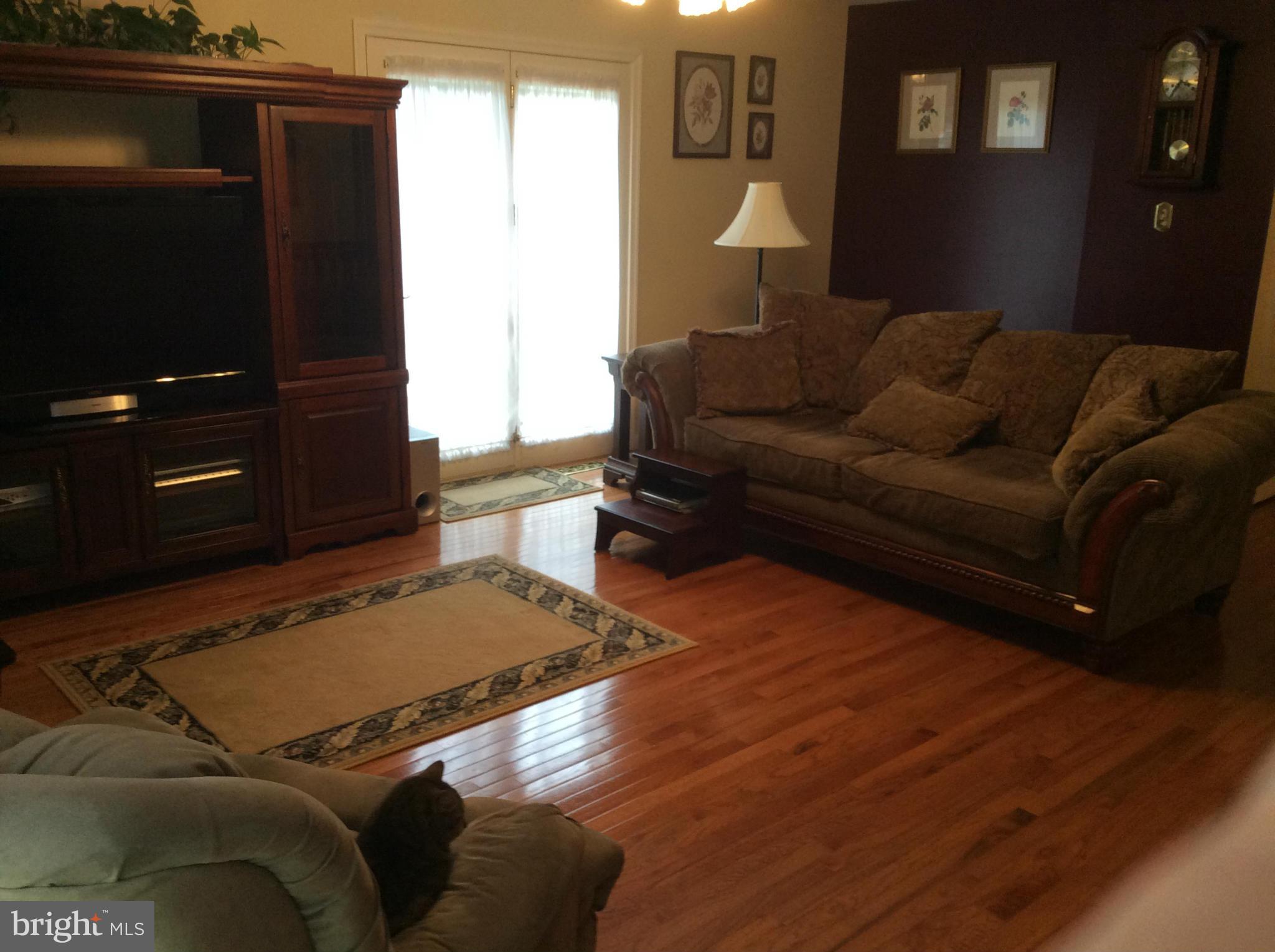 2601 Old Washington Road Westminster, MD 21157 - Photo 8 of 27 a living room with a couch and a flat screen tv