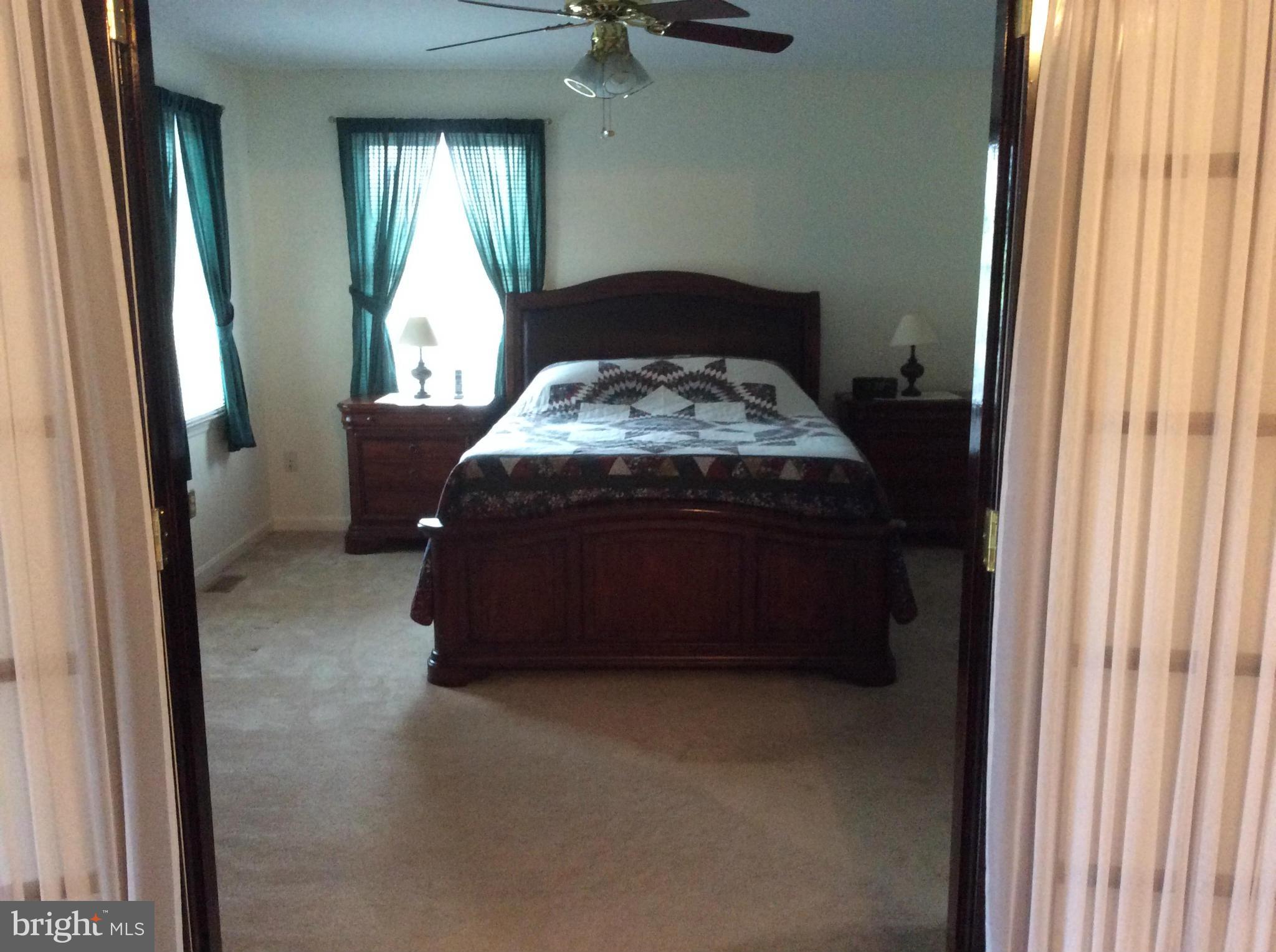 2601 Old Washington Road Westminster, MD 21157 - Photo 10 of 27 a bed sitting in a bedroom next to a window