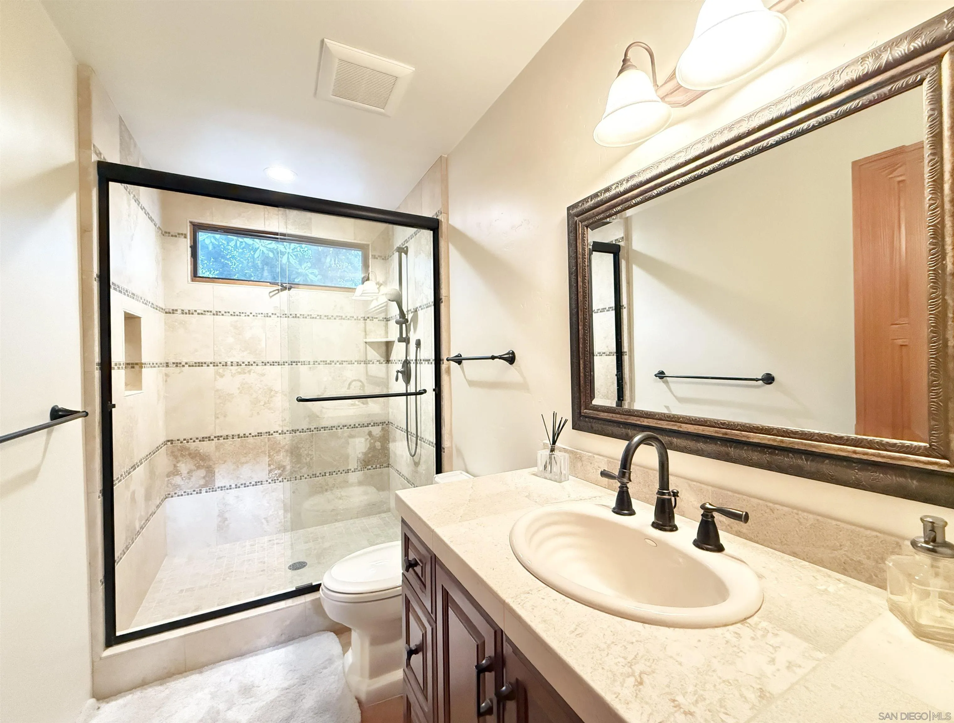 16722 Via Lago Azul Rancho Santa Fe, CA 92067 - Photo 21 of 28 a bathroom with a granite countertop sink toilet and shower