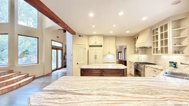 a spacious bedroom with a large bed and a large window