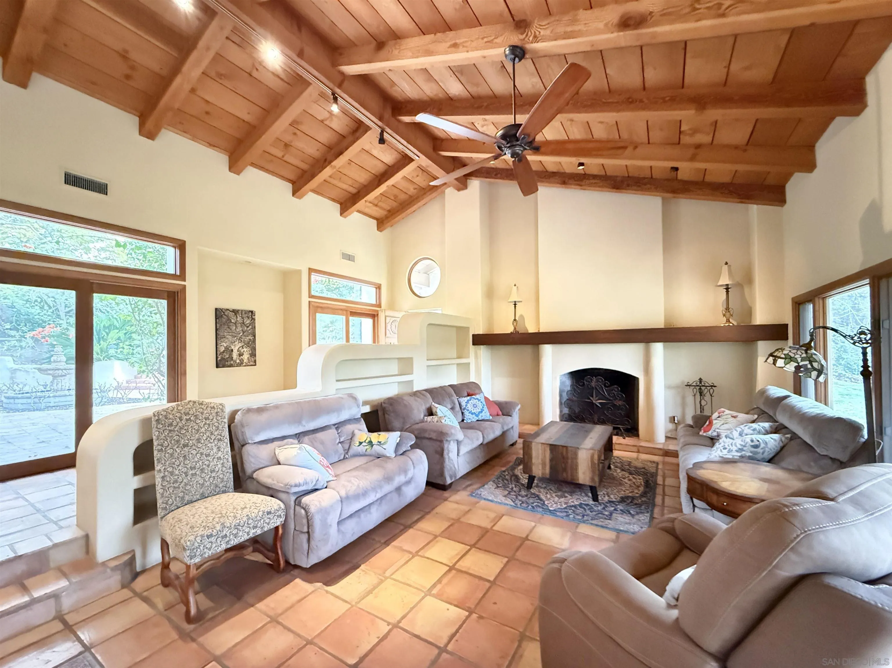 16722 Via Lago Azul Rancho Santa Fe, CA 92067 - Photo 5 of 28 a living room with furniture a fireplace and a flat screen tv