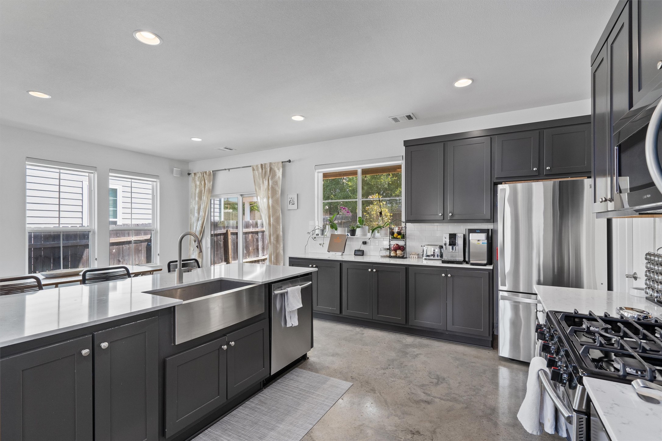 1309 Fort Branch Boulevard Austin, TX 78721 - Photo 2 of 19 a kitchen with stainless steel appliances granite countertop a sink stove and refrigerator