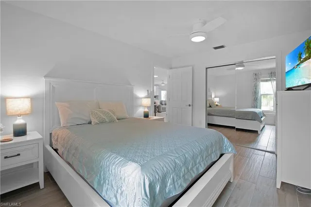 a bedroom with a bed and a lamp