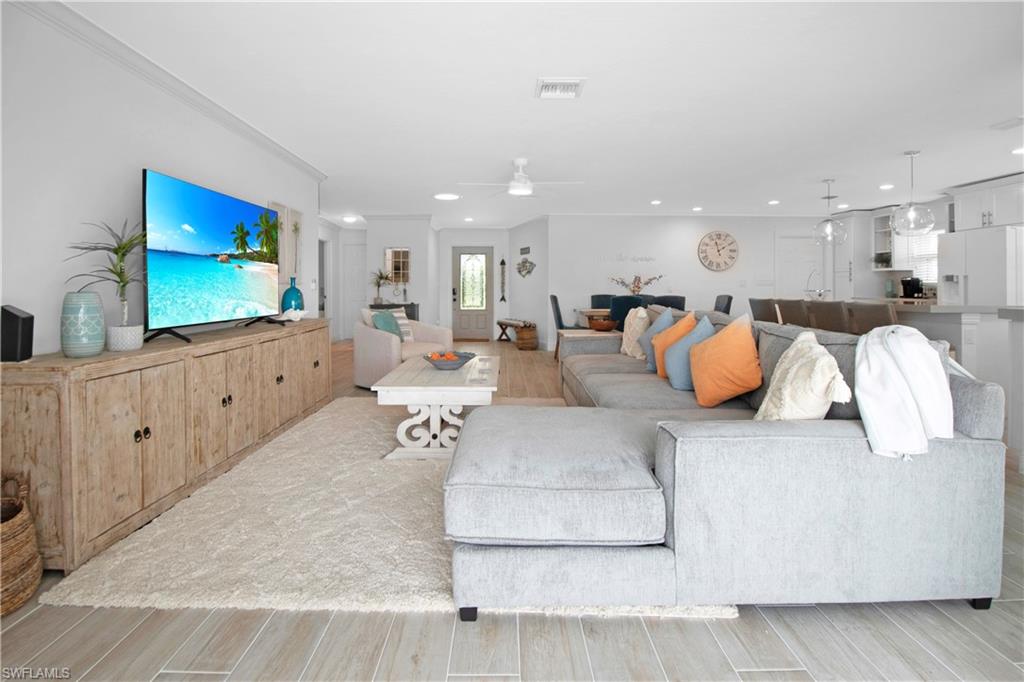 19 East Pelican Street Naples, FL 34113 - Photo 26 of 50 a living room with furniture and a flat screen tv