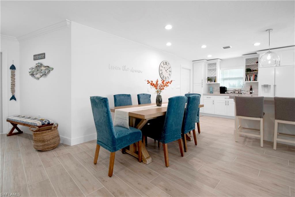 19 East Pelican Street Naples, FL 34113 - Photo 28 of 50 a view of a dining room with furniture and wooden floor