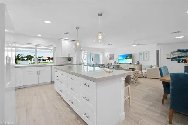 a kitchen with stainless steel appliances kitchen island granite countertop a sink and cabinets