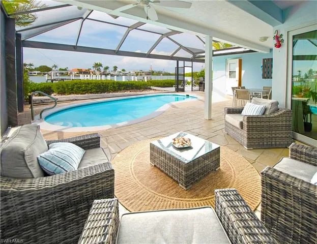a view of a patio with couches and pool