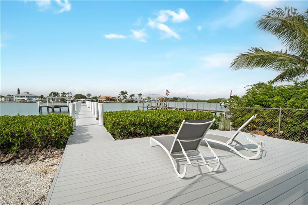 19 East Pelican Street Naples, FL 34113 - Photo 36 of 50 a view of a lake with furniture