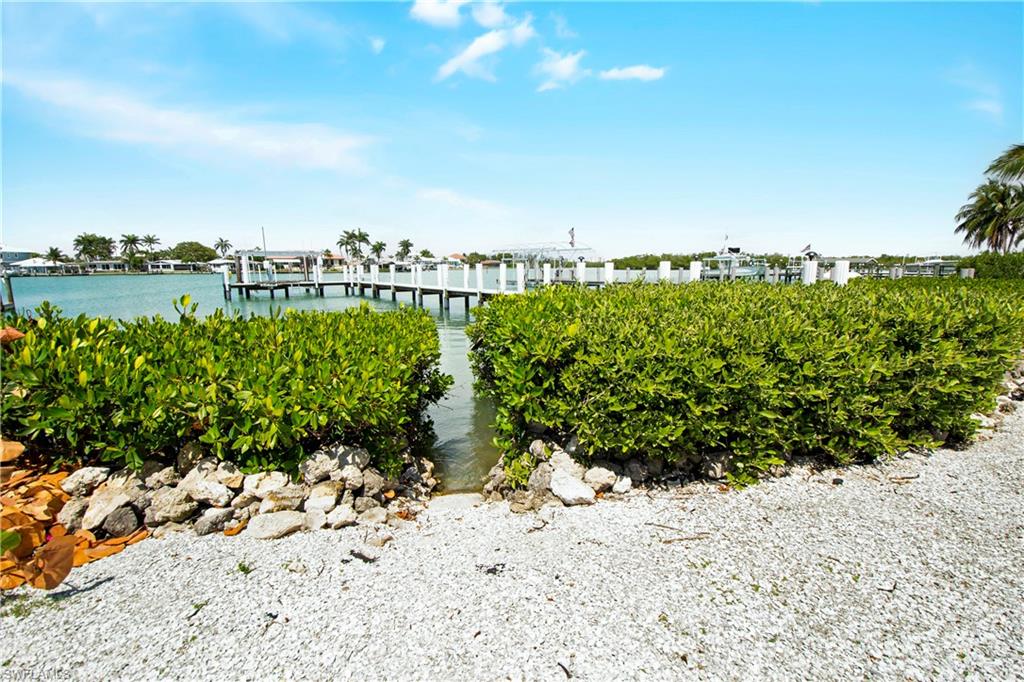 19 East Pelican Street Naples, FL 34113 - Photo 37 of 50 a view of a dry yard with wooden fence