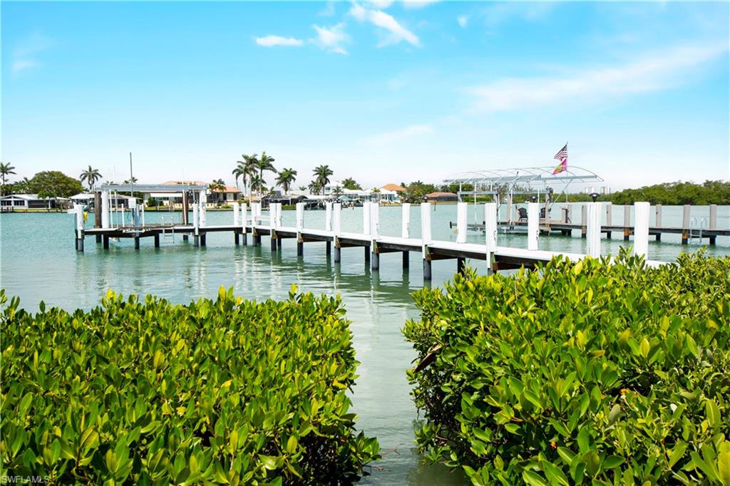 19 East Pelican Street Naples, FL 34113 - Photo 38 of 50 a view of a lake with a sitting area