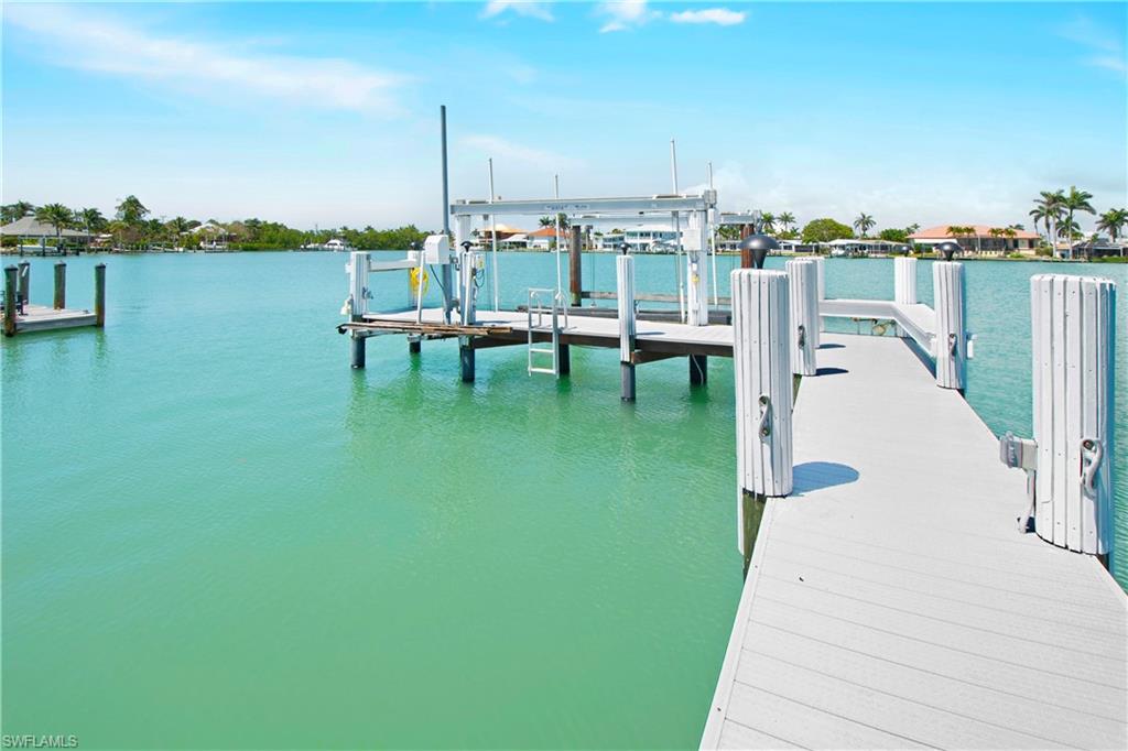 19 East Pelican Street Naples, FL 34113 - Photo 42 of 50 a view of a lake with a bridge
