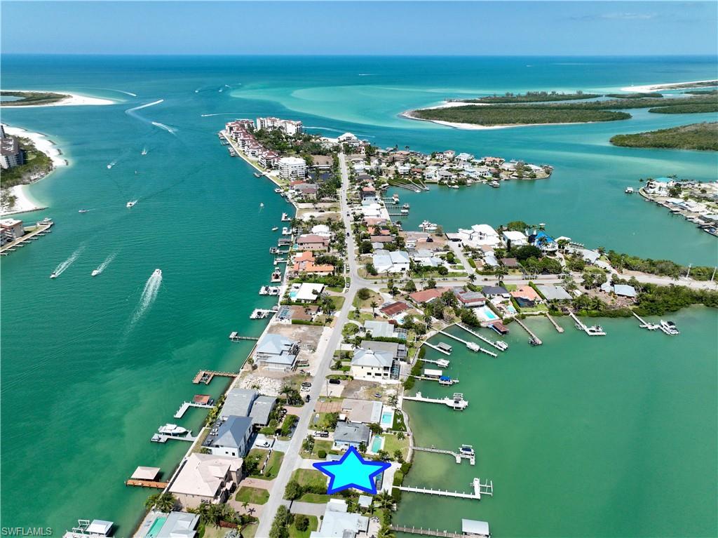 19 East Pelican Street Naples, FL 34113 - Photo 46 of 50 a view of a lake with a big yard