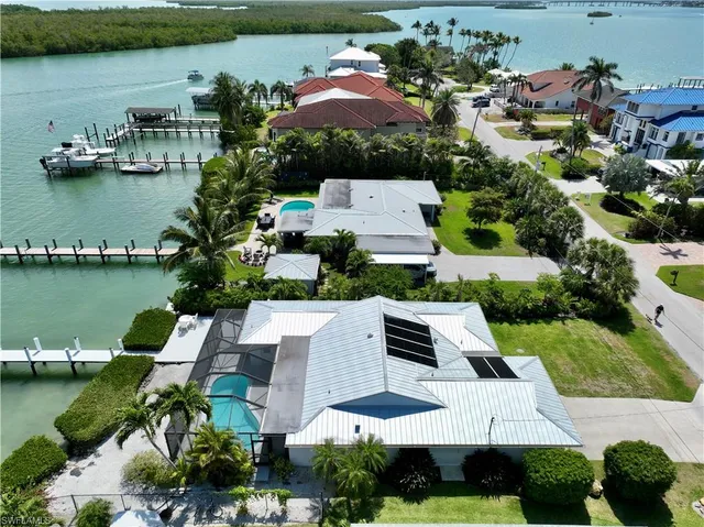 an aerial view of a house with garden space and lake view