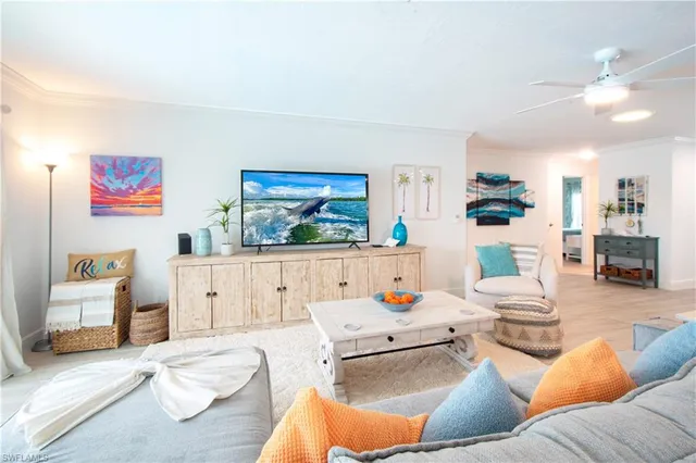 a living room with furniture and painting on the wall