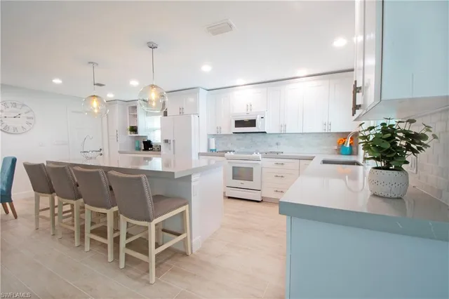 a kitchen with stainless steel appliances kitchen island granite countertop a sink and cabinets