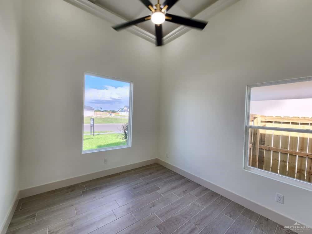 1003 Azalea Street Mission, TX 78573 - Photo 13 of 17 en empty room with windows and ceiling fan