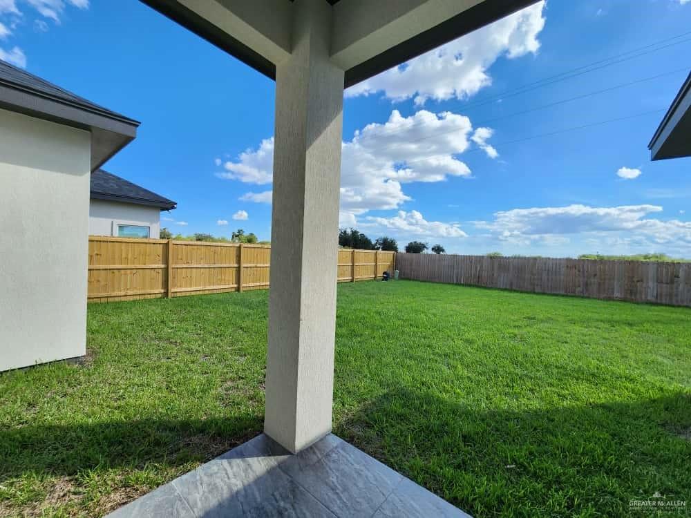 1003 Azalea Street Mission, TX 78573 - Photo 15 of 17 a view of a backyard with garden