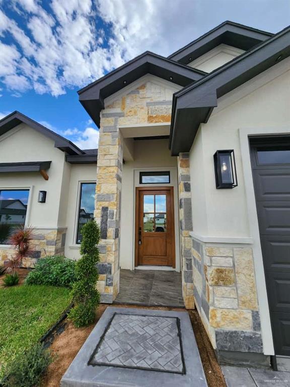 1003 Azalea Street Mission, TX 78573 - Photo 2 of 17 a front view of a house with garden