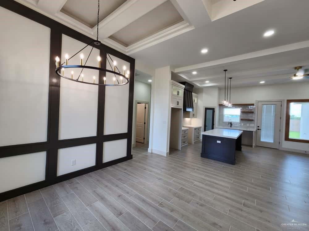1003 Azalea Street Mission, TX 78573 - Photo 5 of 17 a large kitchen with stainless steel appliances kitchen island a large counter top and wooden floors