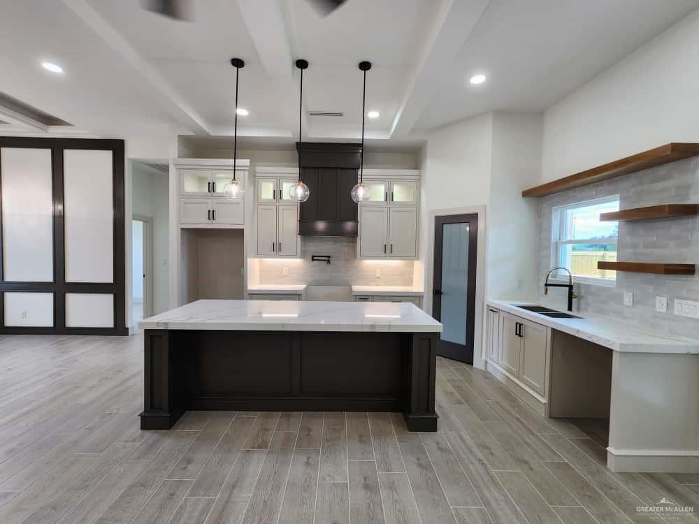1003 Azalea Street Mission, TX 78573 - Photo 6 of 17 a kitchen with stainless steel appliances granite countertop a sink dishwasher a refrigerator and a stove with wooden floor