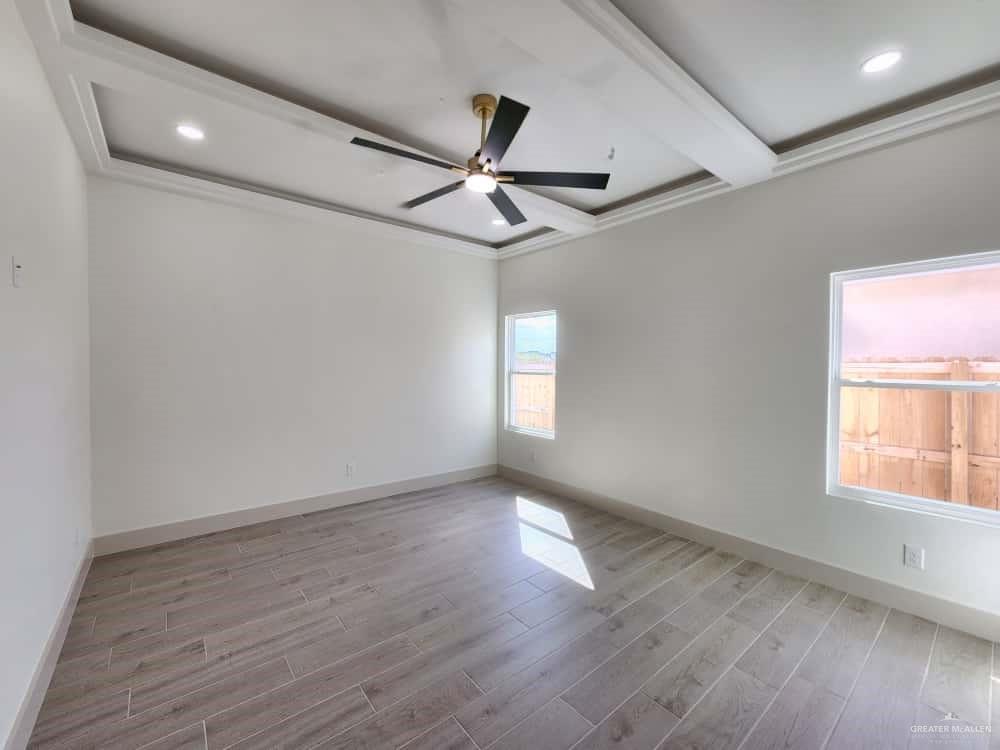1003 Azalea Street Mission, TX 78573 - Photo 9 of 17 a view of empty room with wooden floor and fan