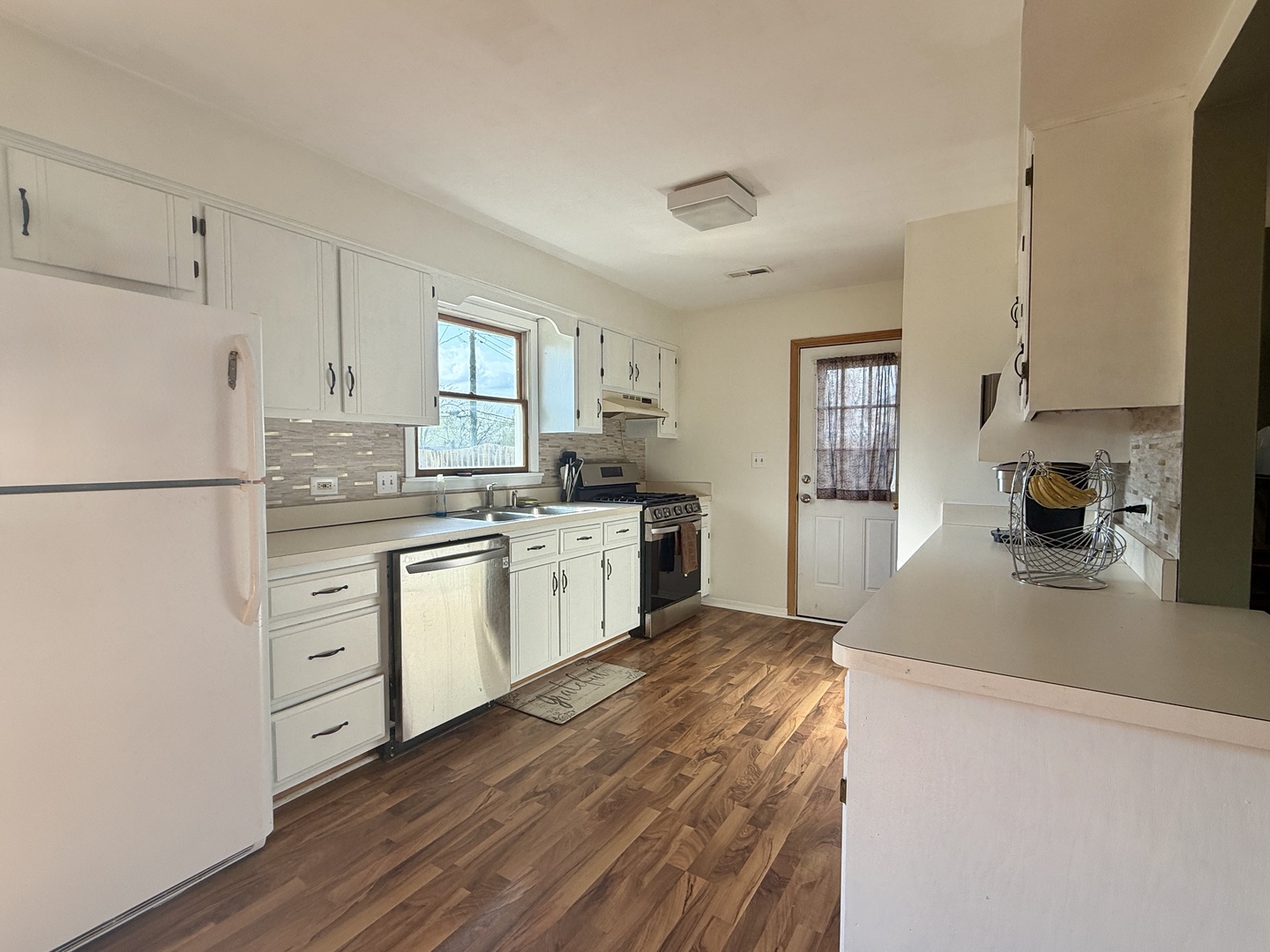 203 MacGregor Road Lockport, IL 60441 - Photo 3 of 12 a kitchen with white cabinets and white appliances