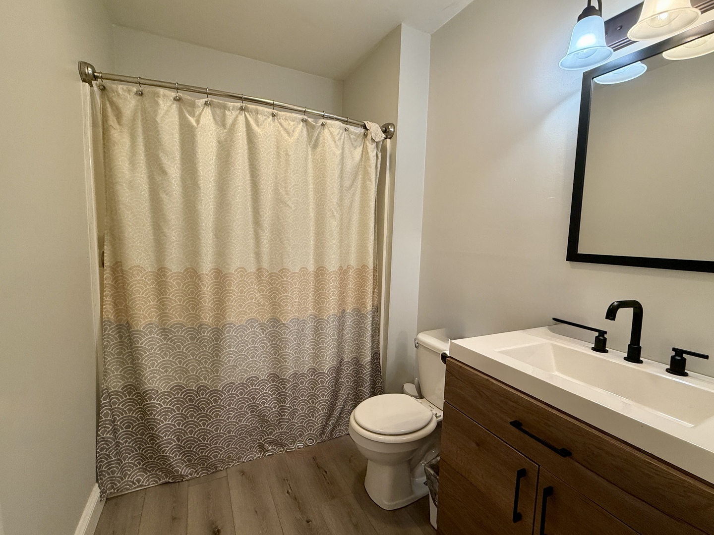 203 MacGregor Road Lockport, IL 60441 - Photo 10 of 12 a bathroom with a sink a toilet and shower curtain
