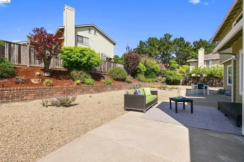 a view of a patio with a table and chairs and potted plants