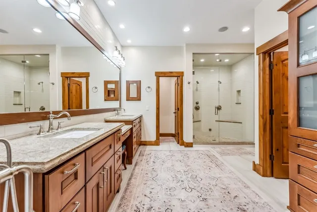 a view of a hallway with a large window and chandelier