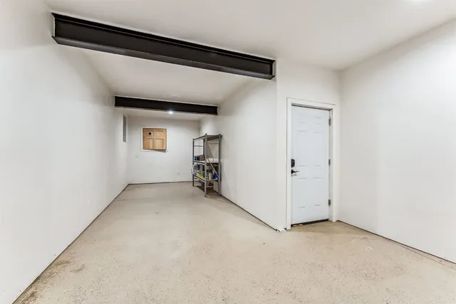 a living room with a piano and a fireplace